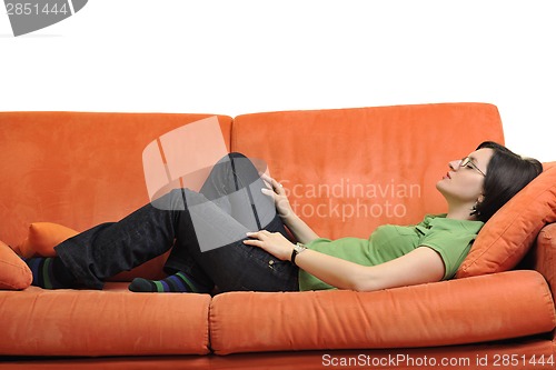 Image of happy young woman relax on orange sofa