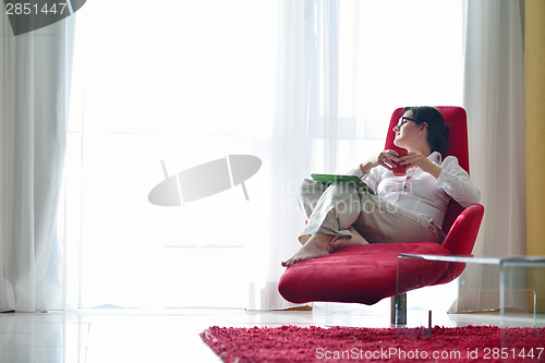 Image of woman using tablet pc at home