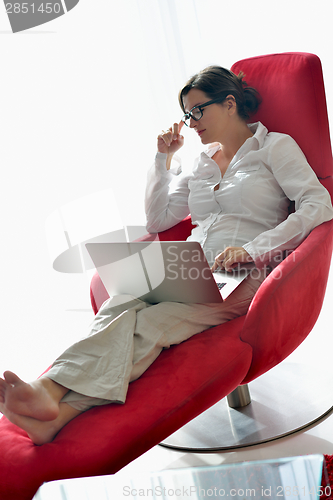 Image of woman using a laptop computer at home