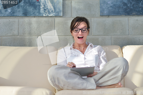 Image of woman using tablet pc at home