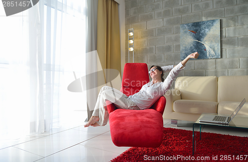 Image of happy young woman relax at home on sofa