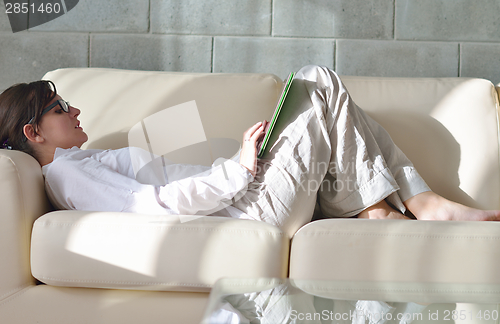 Image of woman using tablet pc at home