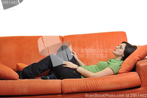 Image of happy young woman relax on orange sofa