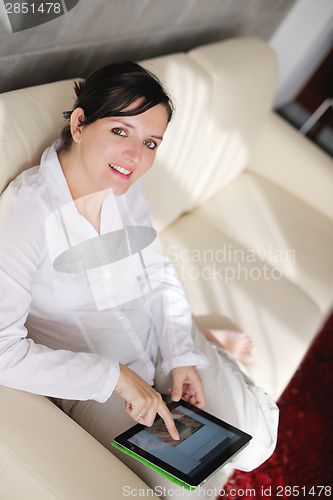 Image of woman using tablet pc at home