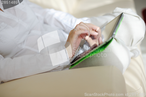 Image of woman using tablet pc at home