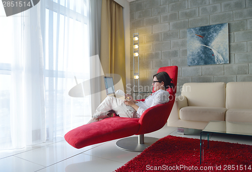 Image of woman using a laptop computer at home