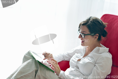 Image of woman using tablet pc at home