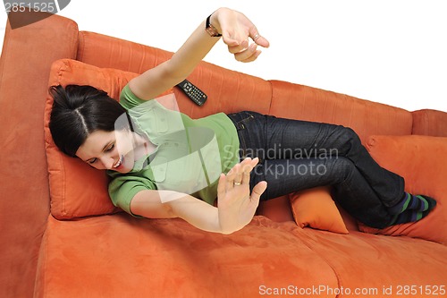 Image of happy young woman relax on orange sofa