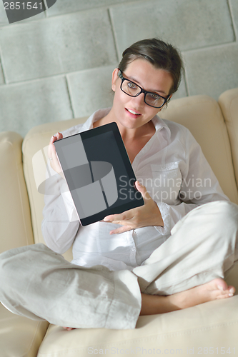 Image of woman using tablet pc at home