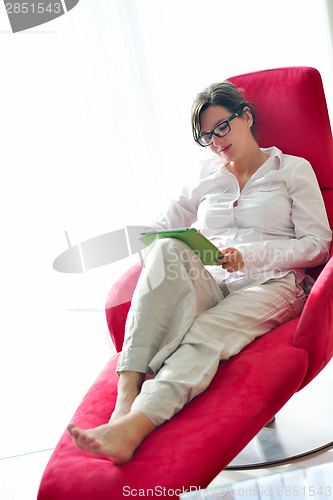 Image of woman using tablet pc at home