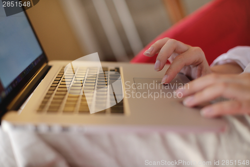 Image of woman using a laptop computer at home