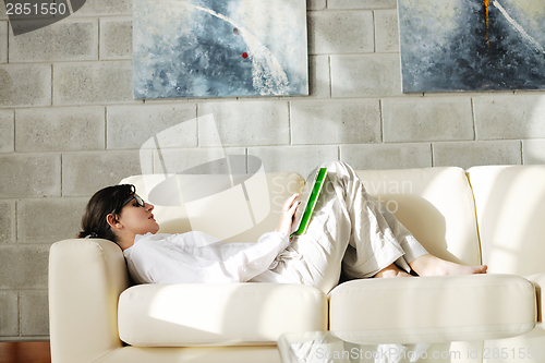 Image of woman using tablet pc at home