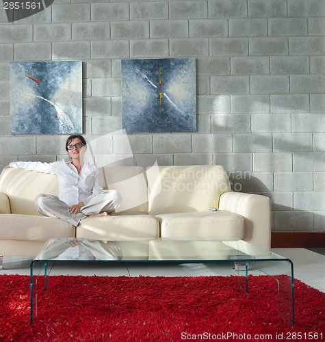 Image of happy young woman relax at home on sofa