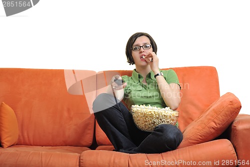 Image of young woman eat popcorn and watching tv