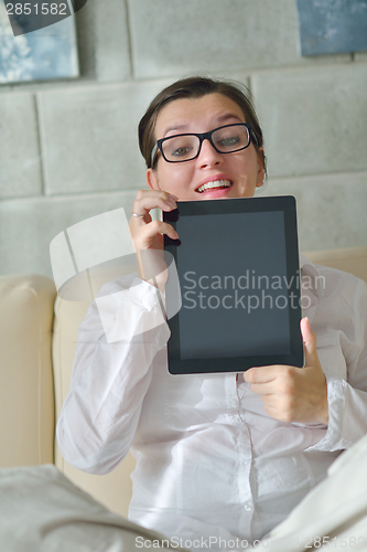 Image of woman using tablet pc at home