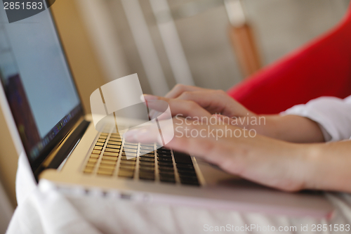 Image of woman using a laptop computer at home