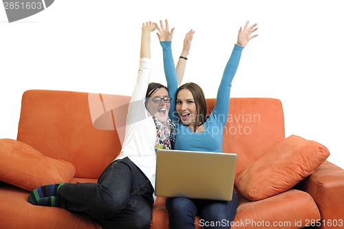 Image of female friends working on laptop computer at home