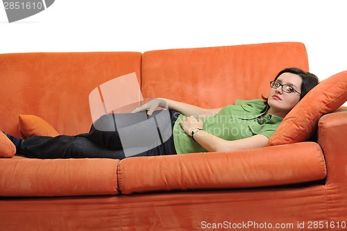 Image of happy young woman relax on orange sofa