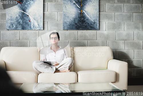 Image of woman using tablet pc at home