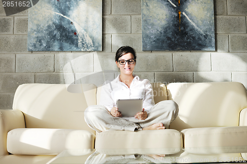 Image of woman using tablet pc at home