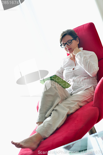Image of woman using tablet pc at home