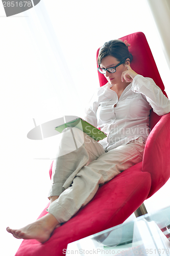 Image of woman using tablet pc at home