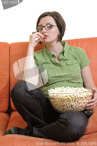 Image of young woman eat popcorn and watching tv