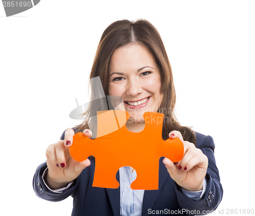 Image of Business woman holding a puzzle piece