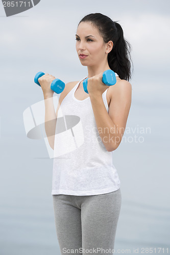 Image of Woman doing exercises with weights 