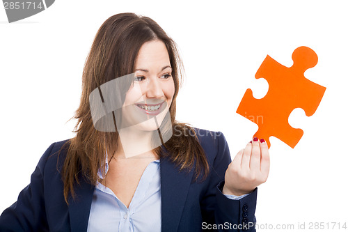 Image of Business woman holding a puzzle piece