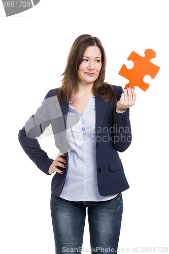 Image of Business woman holding a puzzle piece