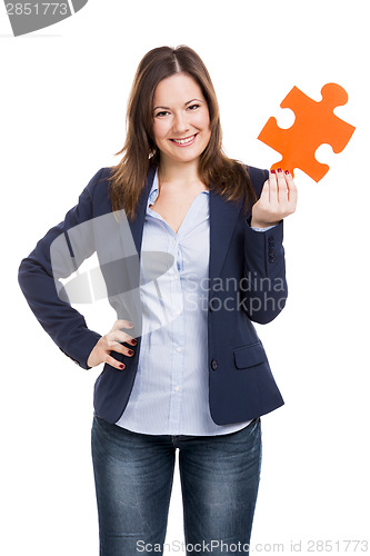 Image of Business woman holding a puzzle piece