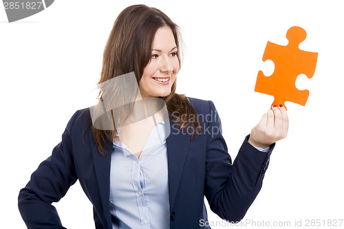 Image of Business woman holding a puzzle piece