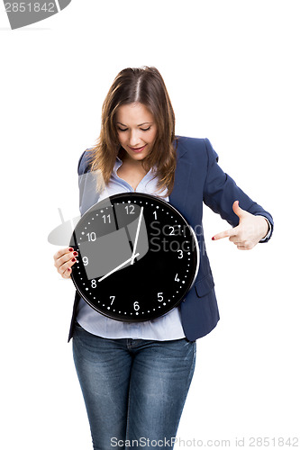 Image of Business woman holding a big clock