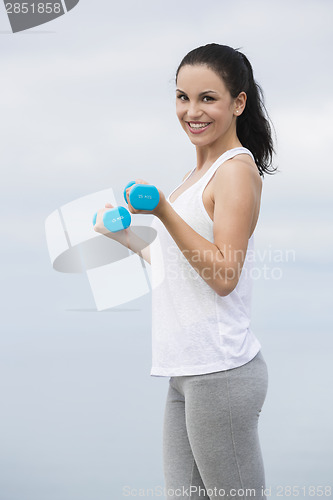 Image of Woman doing exercises with weights 