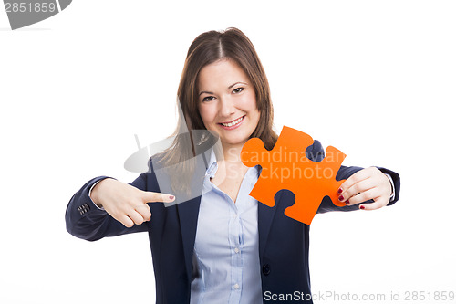 Image of Business woman holding a puzzle piece