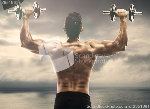 Image of Muscle man lifting weights