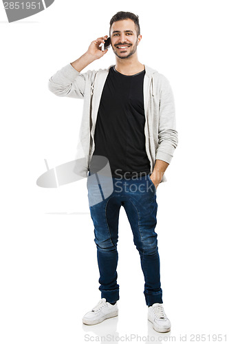 Image of Young man talking on cell phone