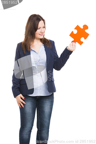 Image of Business woman holding a puzzle piece