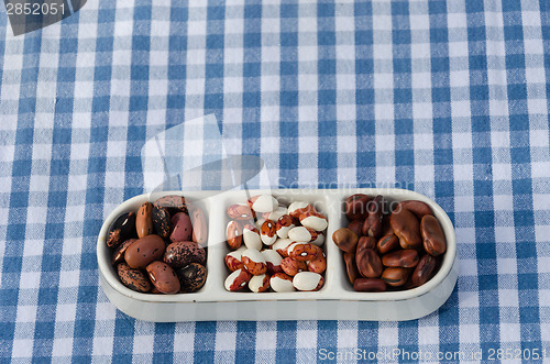 Image of close up of beans three pieces plate on tablecloth 