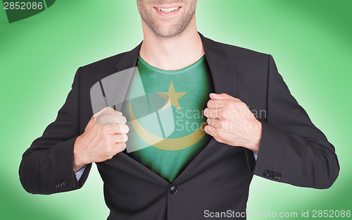 Image of Businessman opening suit to reveal shirt with flag