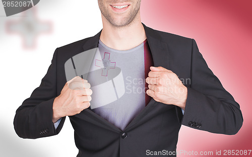 Image of Businessman opening suit to reveal shirt with flag