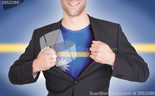 Image of Businessman opening suit to reveal shirt with flag