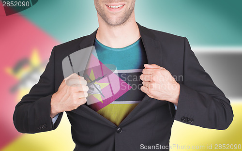 Image of Businessman opening suit to reveal shirt with flag