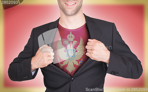 Image of Businessman opening suit to reveal shirt with flag