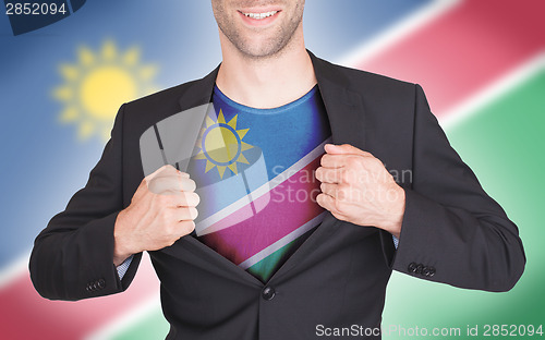 Image of Businessman opening suit to reveal shirt with flag