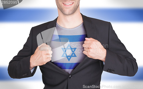 Image of Businessman opening suit to reveal shirt with flag