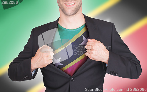 Image of Businessman opening suit to reveal shirt with flag