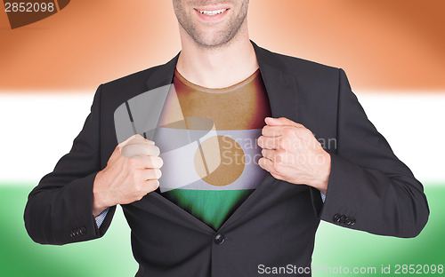 Image of Businessman opening suit to reveal shirt with flag