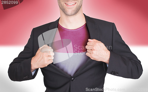 Image of Businessman opening suit to reveal shirt with flag